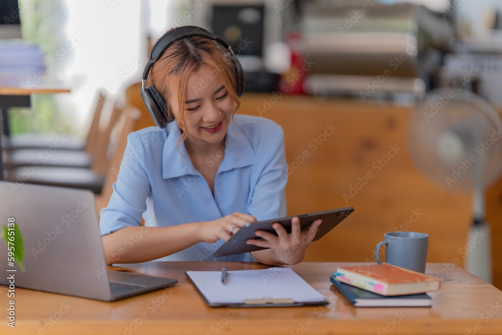 Young student who learns with online platform at coffee shop or co-working space Young student who learns with online platform at coffee shop or co-working space