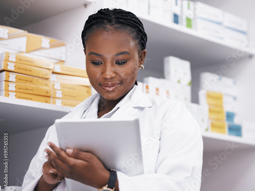 Woman, pharmacist or tablet, online checklist and checking stock of medicine on shelf. African female medical professional reading digital inventory list in pharmacy, healthcare or prescription drugs
