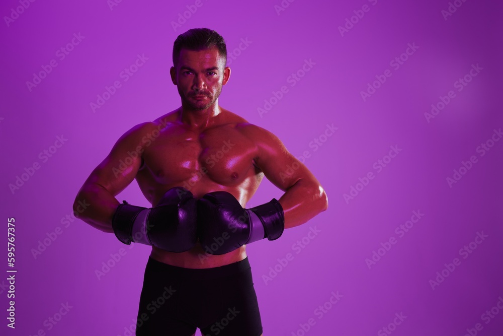 Man bodybuilder boxer muscle workout with naked torso. Advertising, sports, active lifestyle, colored purple light, competition, challenge concept. 