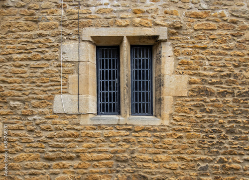Narrow windows set in a thick stone wall in Peterborough, Cambridgeshire, UK