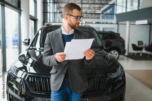 Wallpaper Mural Man adult customer male buyer client wears classic suit white shirt chooses auto wants to buy new automobile touch check car in showroom vehicle salon dealership store motor show indoor. Sales concept Torontodigital.ca