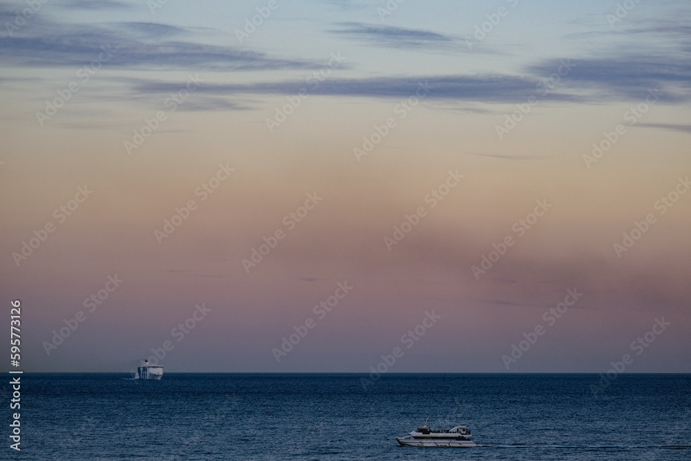 Passenger pax cargo car roro ro-ro ferry boat vessel cruiseship cruise ship liner at sea with sky and coastline