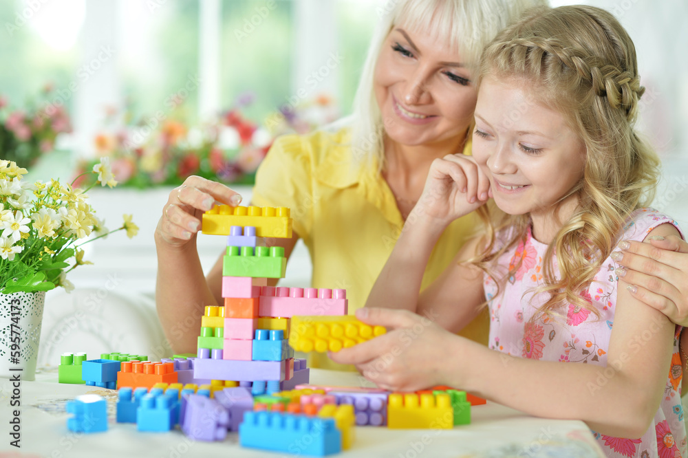 Cute little girl playing with colorful clay blocks at home Cute little girl playing with colorful clay blocks at home
