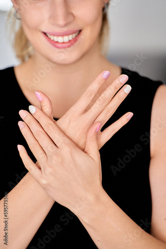 Woman showing her nails after manicure. Manicure and beauty concept.