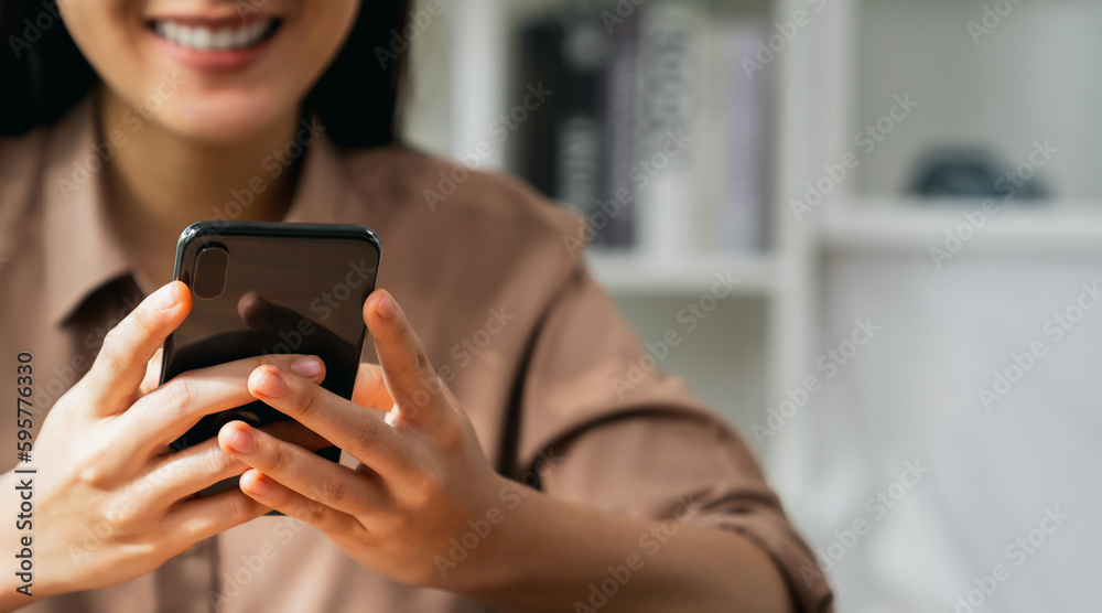 Smiling young woman hand holding smartphone with using social media on internet. Smiling young woman hand holding smartphone with using social media on internet.