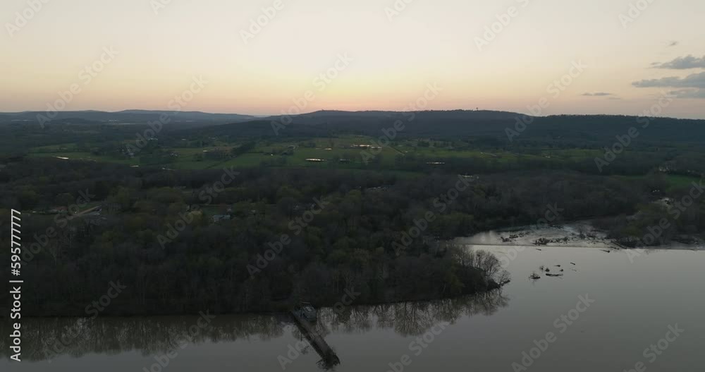 Aerial revealing shot of fallen trees at the shore of Lake Sequoyah during sunset Aerial revealing shot of fallen trees at the shore of Lake Sequoyah during sunset
