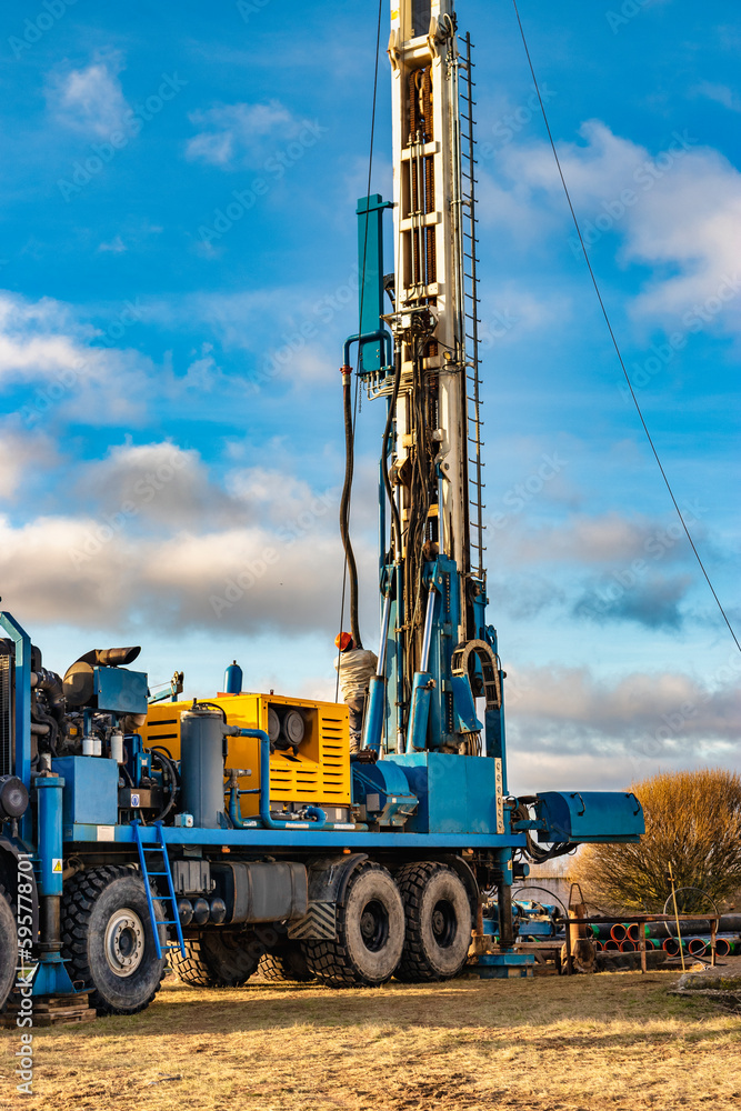 The drilling rig close up. Powerful drilling rig against a cloudy sky. Deep hole drilling. Geological exploration work. Mineral exploration. Extraction of gas and oil.