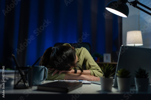 Exhausted freelance asia woman from overwork, lying at. Working from house overload at night