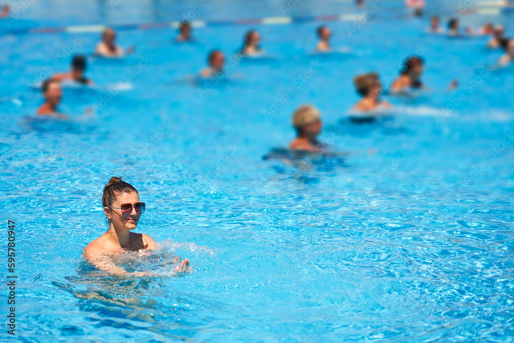 Image of young woman on aqua aerobic in pool