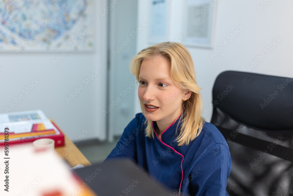 Woman doctor in uniform work with document in private clinic. Nurse sitting behind desk in office, checking medical history or anamnesis of client, reading patient treatment plan - obrazy, fototapety, plakaty 