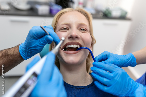 Teeth health concept. Cropped photo of smiling woman mouth under treatment at dental clinic  panorama
