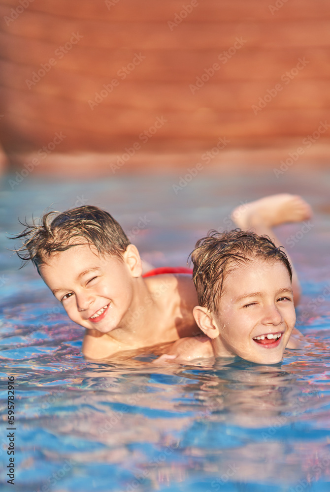 Picture of brothers playing in outdoor aqua park pool Picture of brothers playing in outdoor aqua park pool
