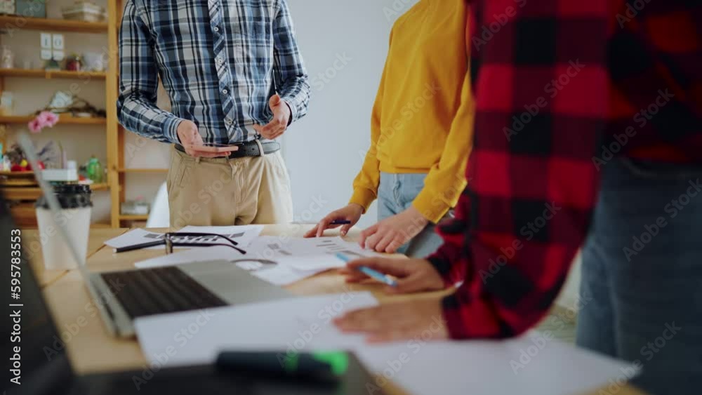 Business people office workers working together stand near desk, hands close-up. Colleagues discussing project holding smartphone in hands. Working process, meeting conversation, teamwork concept. Business people office workers working together stand near desk, hands close-up. Colleagues discussing project holding smartphone in hands. Working process, meeting conversation, teamwork concept.