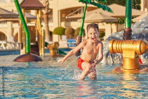 Picture of young boy playing in outdoor aqua park