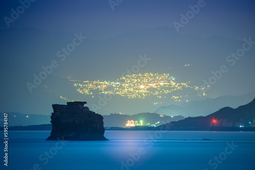 Misty village. The hazy and dreamy night scene of the mountain city. Overlooking the night view of Jiufen from Jinshan across the sea  Taiwan.