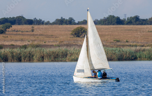 Small sailing boat sailing on a small lake. 