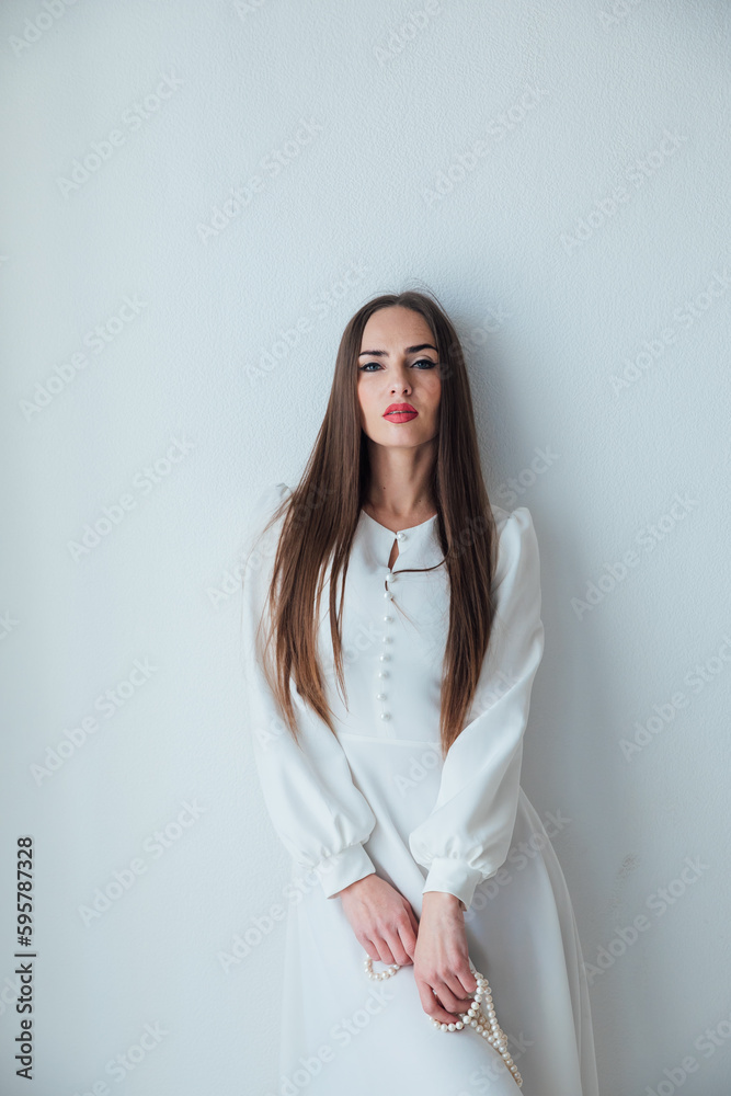 beautiful woman with beaded beads posing on a white fashion background beautiful woman with beaded beads posing on a white fashion background