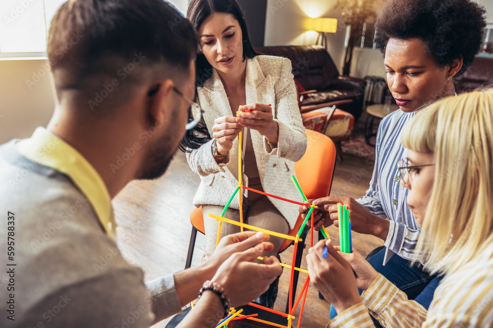 Team building activities in the office with sticks.Concept of friendship, teambuilding and