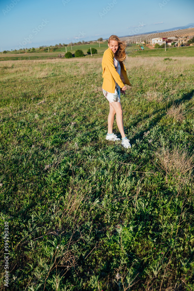 walk a blonde woman walking in nature on the green grass in the field journey walk a blonde woman walking in nature on the green grass in the field journey