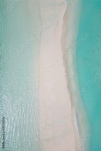 stunning blue ocean and sandy white island maldives top drone aeral view deserted hidden Maldives beach copyspace for text © yurakrasil
