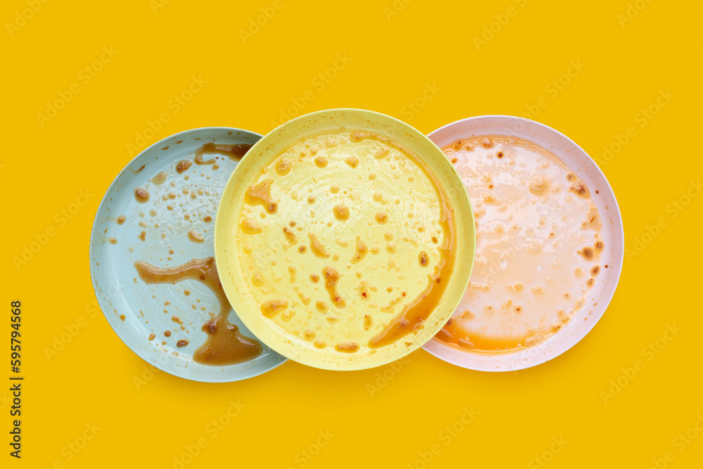 Dirty dishes on yellow background. Top view Dirty dishes on yellow background. Top view