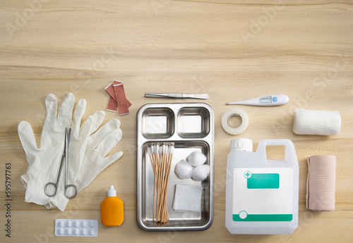 Emergency first aid kit on wooden table Horizontal composition, top view healthcare and medical