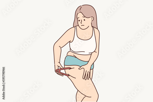 Woman measures percentage of fat on legs using calipers tracking result of diet for weight loss 