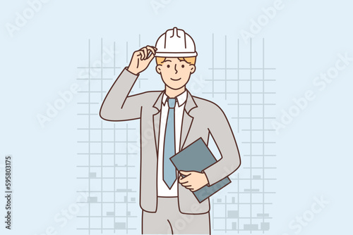 Business man in protective helmet working as manager in construction or architectural company