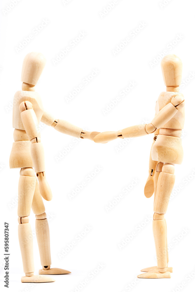 Two mannequins closing a deal by shaking hands on a white background. Concept of success Two mannequins closing a deal by shaking hands on a white background. Concept of success