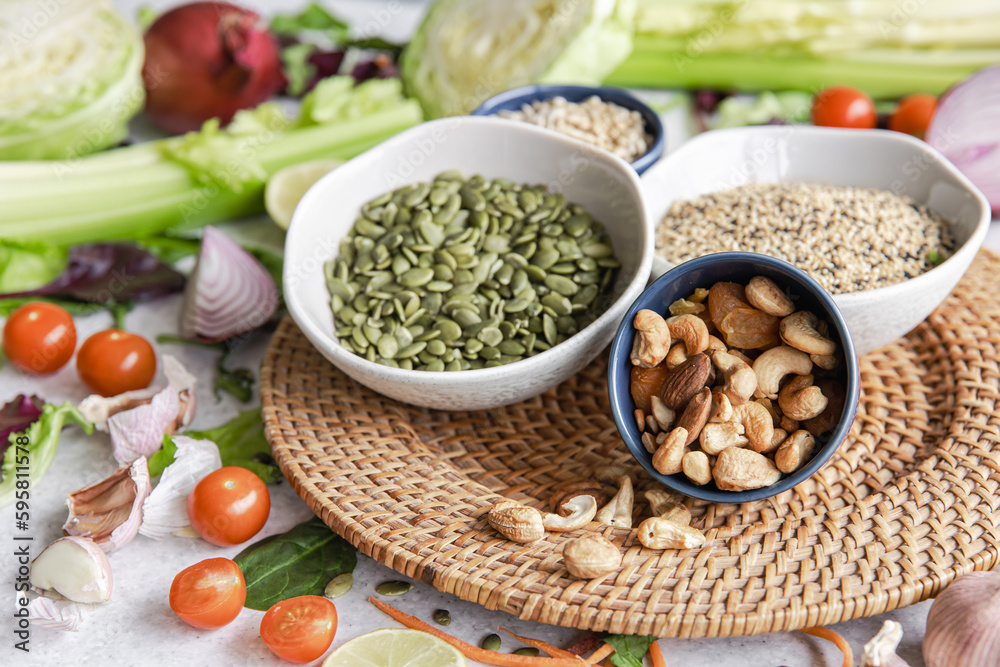 Pumpkin seeds, nuts and chia seeds and other healthy foods on the kitchen table.