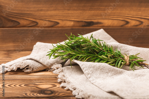 Fototapeta Naklejka Na Ścianę i Meble -  Branches of fresh rosemary on a brown texture background. Spicy spices. Seasoning for meat and fish. Cooking concept. RECEPT. Close-up. place for text.