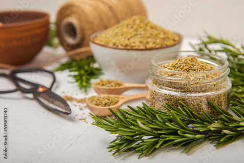 Dried rosemary and branches of fresh rosemary on a white texture background. Spicy spices. Seasoning for meat and fish. Cooking concept. RECEPT. Close-up. place for text. photo