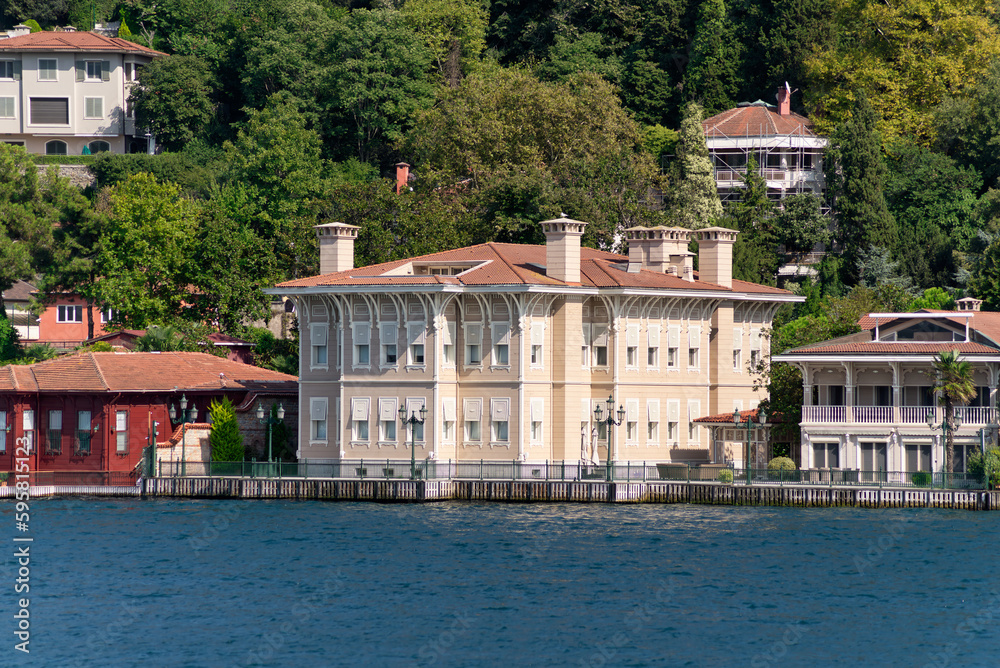 View from Bosphorus strait of the green mountains of the Asian side, with traditional houses and dense trees in a summer day, Istanbul, Turkey