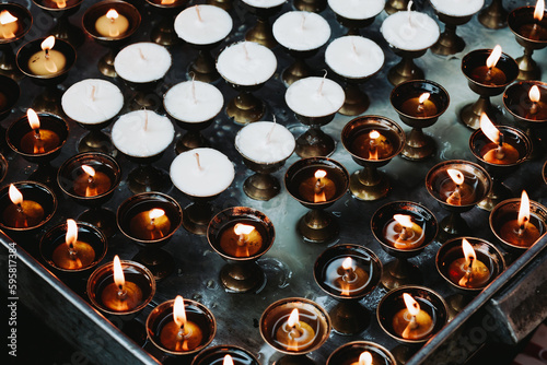 Burning candles in Buddhist Stupa photo