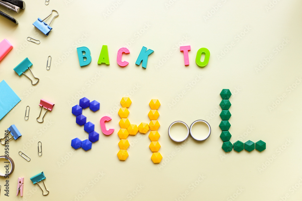 Flat lay inscription back to school on a yellow background and stationery Flat lay inscription back to school on a yellow background and stationery