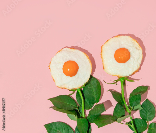 Fototapeta Naklejka Na Ścianę i Meble -  Spring creative layout with fried eggs and rose flower stems on pastel pink background. 80s or 90s retro fashion aesthetic bloom concept. Minimal romantic surreal cosmetic idea.