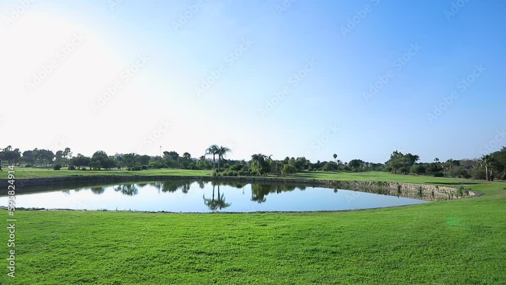 Lake and palm trees in an Egyptian garden - pan right Lake and palm trees in an Egyptian garden - pan right