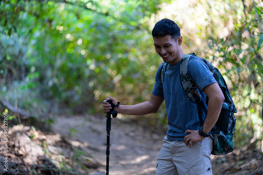 Tired and tired Asian male traveler with trekking gear and backpack resting. Take a break on your way from hiking, tourism concept. Tired and tired Asian male traveler with trekking gear and backpack resting. Take a break on your way from hiking, tourism concept.