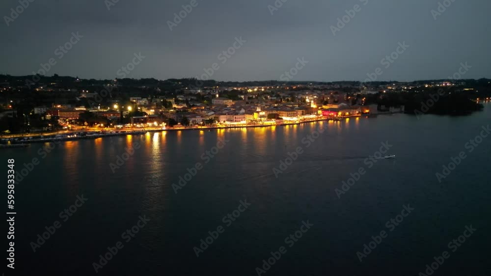 Aerial View Of Lazise Comune At Night With Marina On Lago di Garda In Italy. Aerial View Of Lazise Comune At Night With Marina On Lago di Garda In Italy.