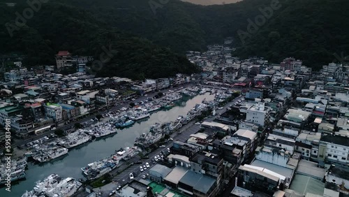 Nanfang'ao Nanfangao Fishing Port Harbor at Sunset 南方澳漁港 Taiwan East Coast Yilan County, Aerial Drone Dolly, Fishing Town surrounded by Mountains photo