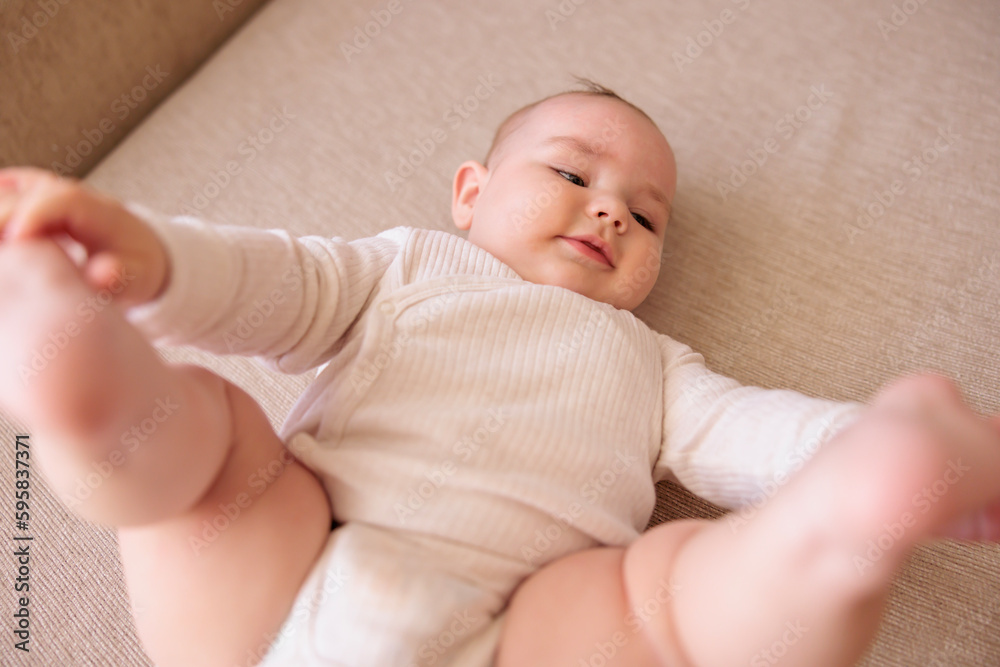Baby boy playing while mommy is changing his diaper Baby boy playing while mommy is changing his diaper