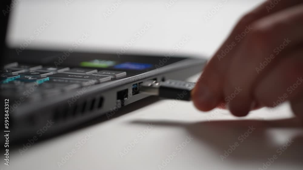 Closeup hand of unrecognizable man disconnecting data cable into USB