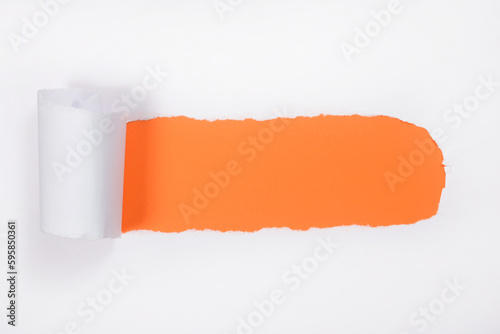 Torn white paper with curled edges. orange under white paper