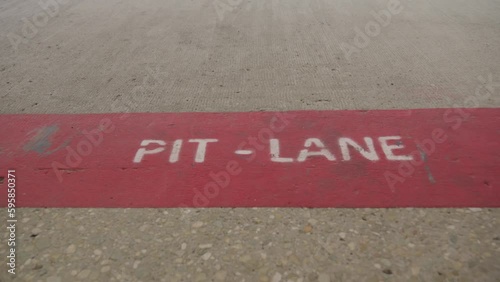 The inscription pitlane on the asphalt of the Formula 1 race track. High quality 4k footage. Slow motion