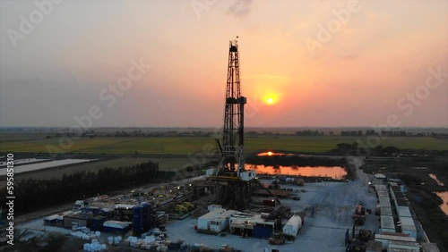 Sunset oil drilling rig in the field