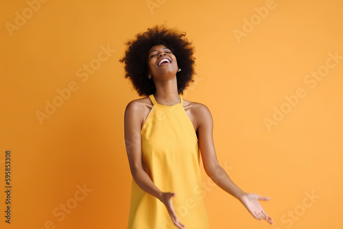 A black woman in a yellow dress is laughing