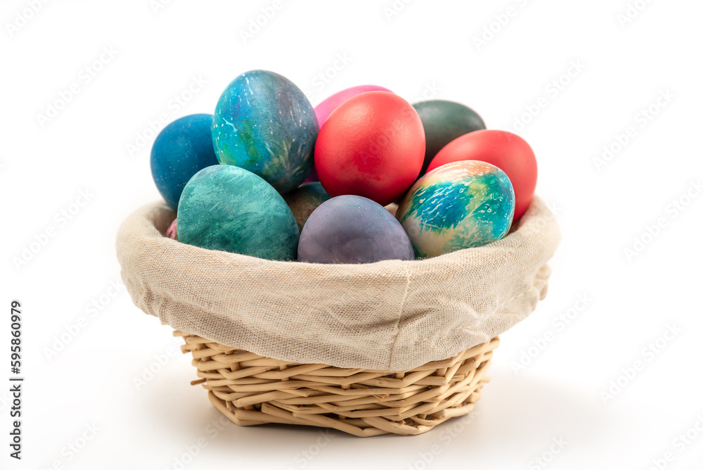Multi colors Easter eggs in the woven basket isolated on white background with clipping path Multi colors Easter eggs in the woven basket isolated on white background with clipping path