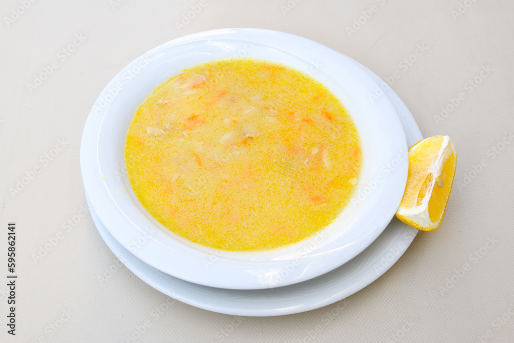 Homemade turkish soup Tavuk Suyu corbasi in a white ceramic soup plate.Turkish noodle chicken broth soup on a plate. Turkish meal (sehriyeli tavuk suyu corbasi) Homemade turkish soup Tavuk Suyu corbasi in a white ceramic soup plate.Turkish noodle chicken broth soup on a plate. Turkish meal (sehriyeli tavuk suyu corbasi)