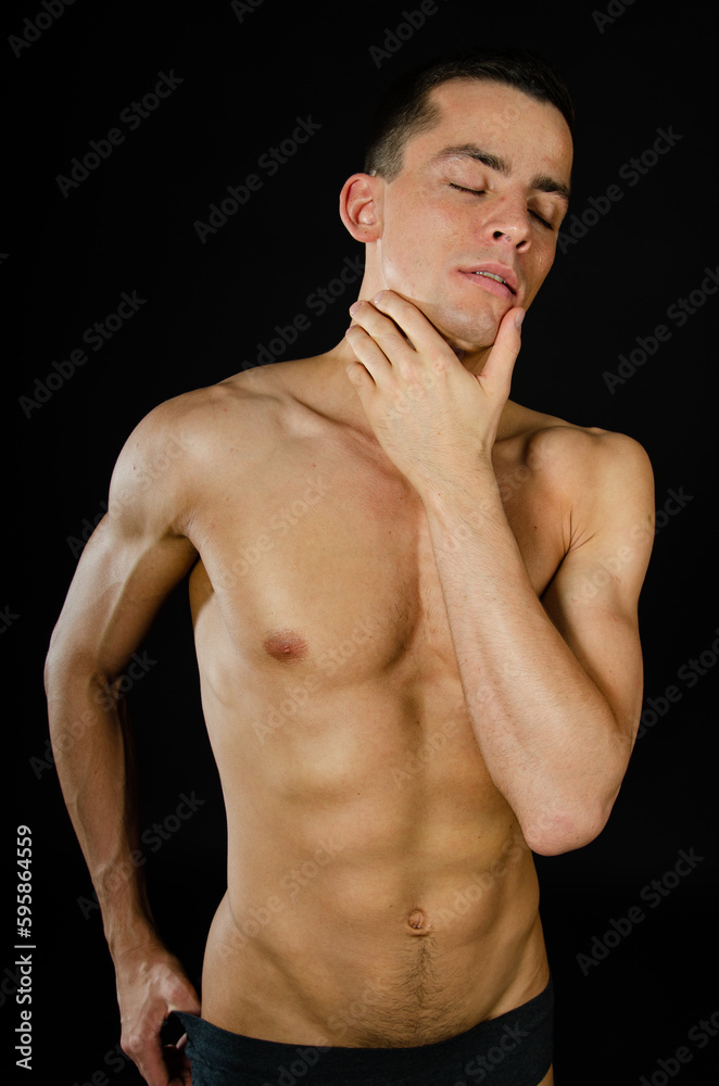 Young attractive man posing in the studio. Young attractive man posing in the studio.
