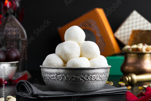 Rasgulla is a milk based sweet made by curdling milk photo